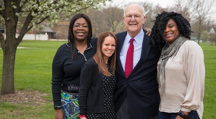 Paul Weatherly standing with Cavanaugh scholars Cynthia Reid, Christina Hushen, and Ja'Net Reid-Jones