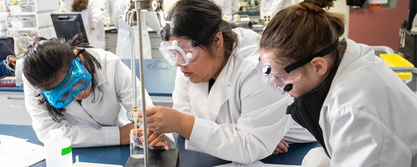 Three Biological Sciences students working in a lab