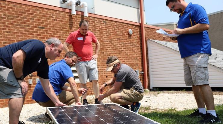 Individuals attending the College’s STEM Educator Energy Institute collect voltage and current data from a solar panel.